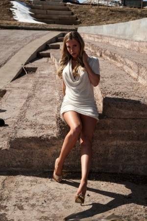 Hot blonde in white dress flashes pierced tits & naked pussy upskirt outdoors on dochick.com