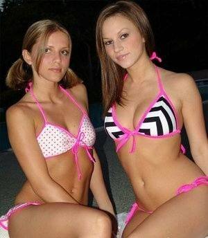 Young lesbians take off their bikinis in a safe for work manner at night on dochick.com