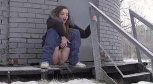 White girl pulls down her jeans to pee in the snow behind a building on dochick.com