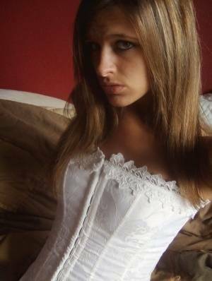 Teen in white corset and tight panties showing off her perfect tight body on dochick.com