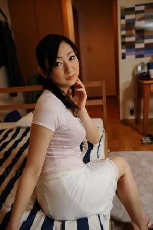 Slender mature Japanese woman Emiko Koike bends over to pose in white dress - Japan on dochick.com