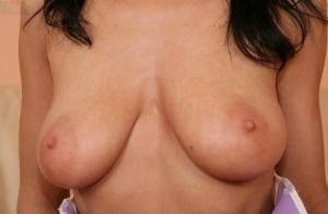 European babe freeing big MILF tits from uniform before masturbating on dochick.com