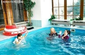 Playful fetish ladies have some fully clothed fun in the pool on dochick.com