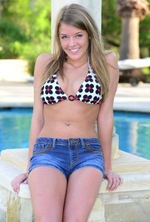 Cute teen Sophia Wood drops her shorts by the pool to toy with a vibrator on dochick.com
