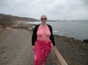Aged lady Barby looses her big tits from a crotchless bodystocking by the sea on dochick.com
