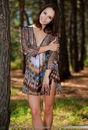 Sweet teen with an ass to die for disrobes for great nude poses in a forest on dochick.com