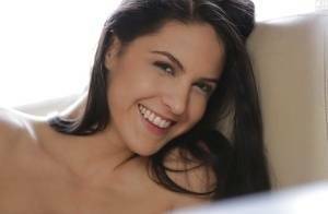 Latina pornstar Carolina Abril strips off her white bra and panties on dochick.com