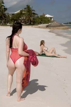 Plump female Christy Mark and her big boobed friend have lesbian sex on beach on dochick.com