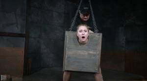Blonde girl Odette Delacroix is made to suck a black cock with head in stocks on dochick.com