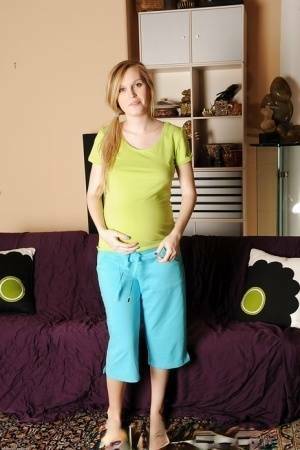 Smiley pregnant amateur with puffy nipples and hairy gash getting naked on dochick.com