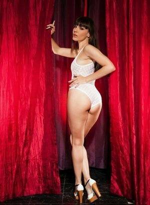 Leggy brunette Dana Dearmond sets her boobs free from bodysuit in heels on dochick.com