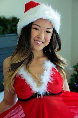 Cute Asian teen Lulu Chu wears Xmas lingerie during sex on a bed on dochick.com