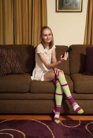 Adorable teen Alicia Williams takes a selfie before getting naked in OTK socks on dochick.com
