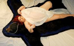 Fat redhead Black Widow AK models totally naked on a bearskin rug on dochick.com