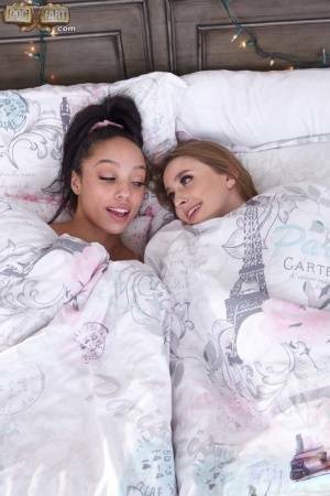 Interracial lesbians lick assholes and pussies on a bed in sport socks on dochick.com