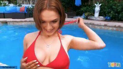 Gracie Gates coyly undoes her top in the pool on dochick.com