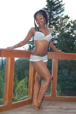 Black girl Amber uncups her big tits while getting in an outdoor hot tub on dochick.com